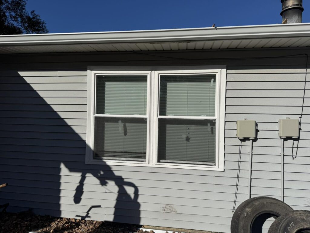 Residential vinyl siding and window installation on home by J Cole Roofing & Construction in Austin AR