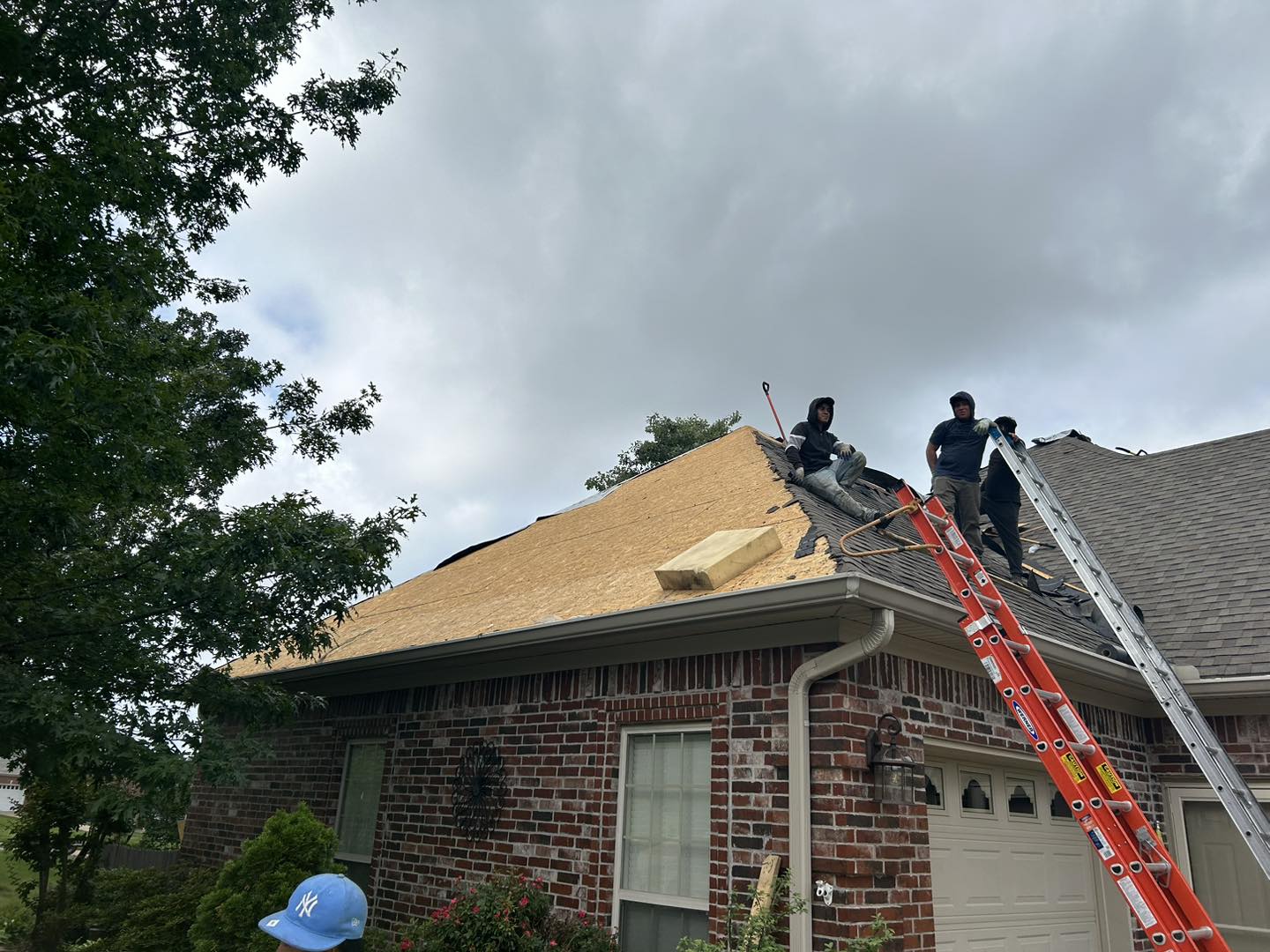 Roofing crew installing new residential roof by J Cole Roofing & Construction in Austin AR