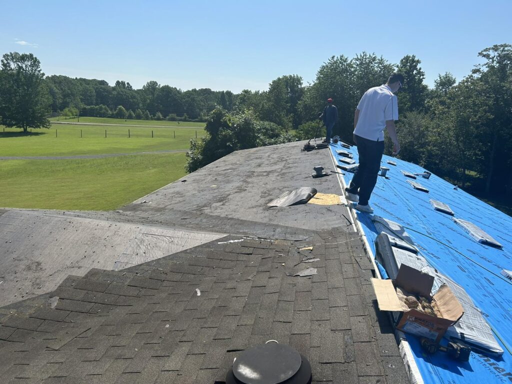 Roofing contractor walking roof during replacement project by J Cole Roofing & Construction in Central Arkansas