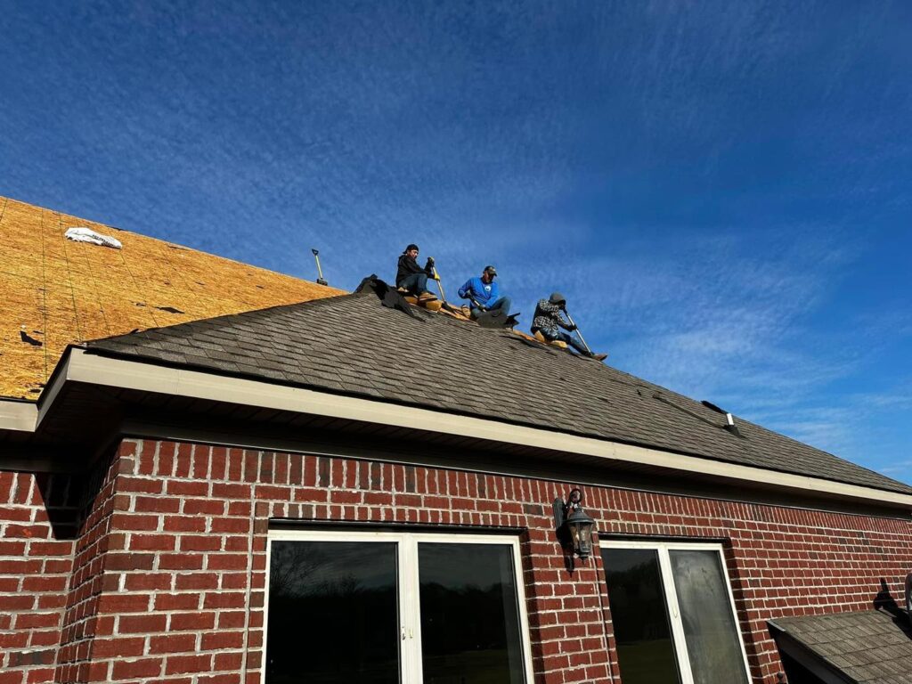 Roofing crew installing asphalt shingle roof by J Cole Roofing & Construction in Austin AR