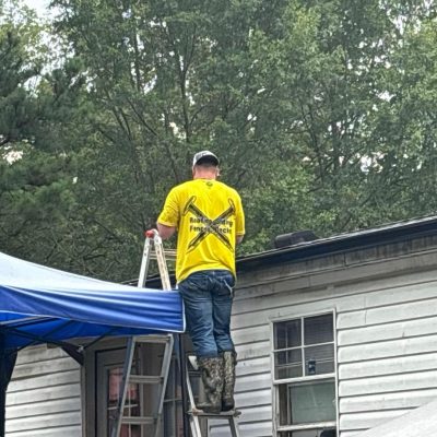 Roofing contractor inspecting residential roof by J Cole Roofing & Construction in Central Arkansas